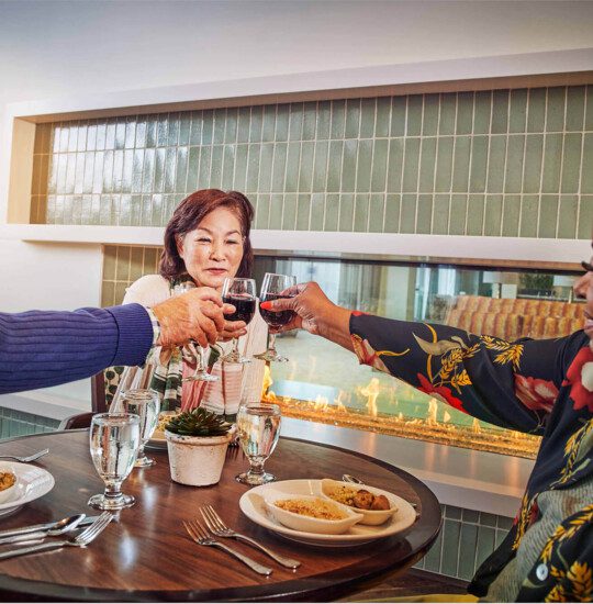 Three adults sharing a drink