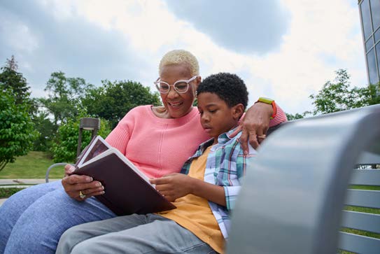 Grandmother reading with her grandson